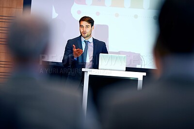 Buy stock photo A confident businessman gesturing while giving a presentation at a press conference