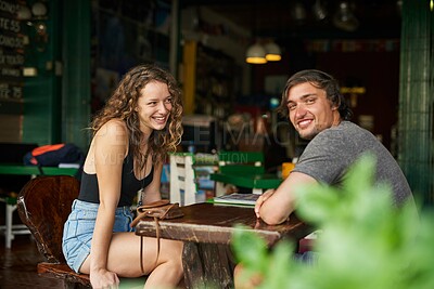 Buy stock photo Portrait of a happy young man enjoying lunch in a restaurant with his girlfriend