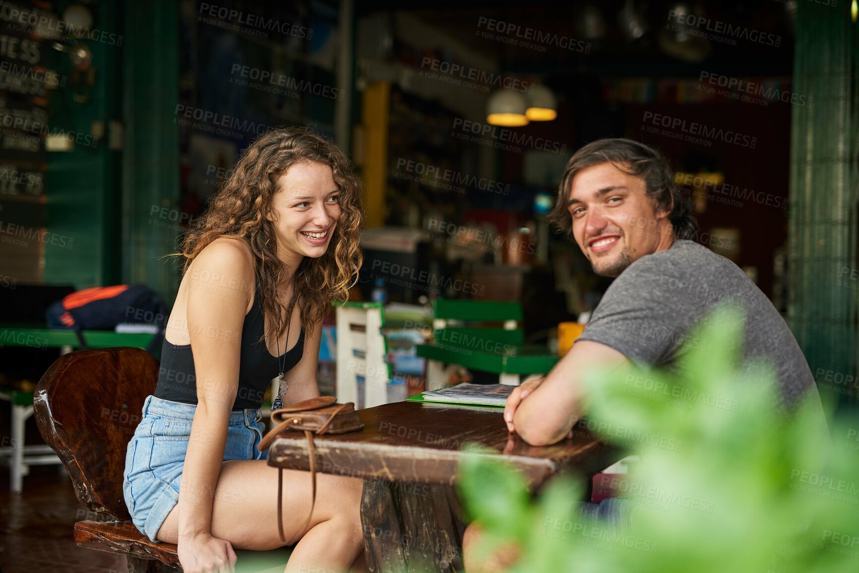 Buy stock photo Portrait of a happy young man enjoying lunch in a restaurant with his girlfriend