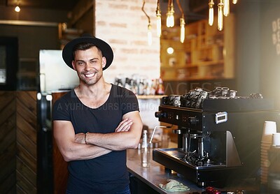 Buy stock photo Shot of a handsome young man working behind the counter of a coffee shop