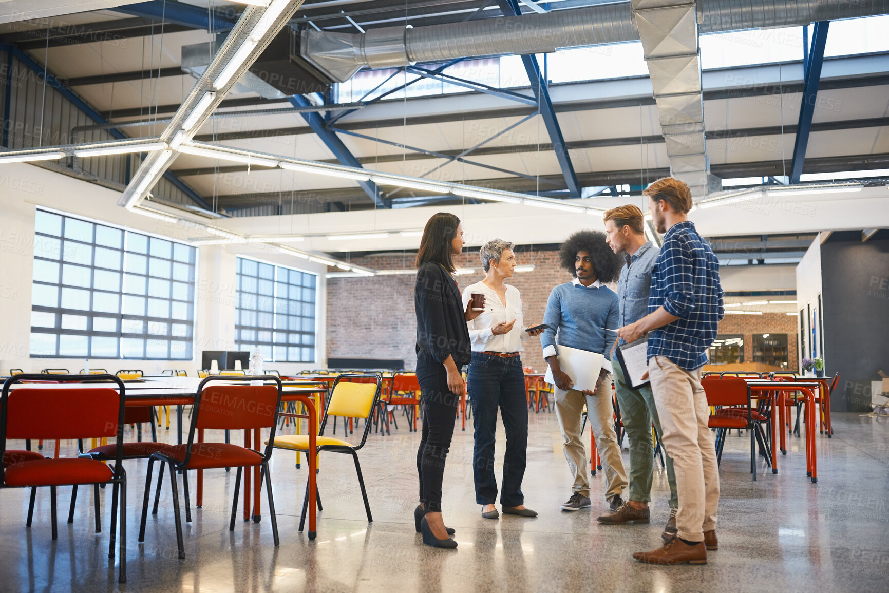Buy stock photo Full length shot of a group of designers talking while standing around in their office