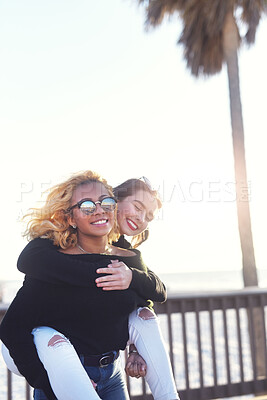 Buy stock photo Cropped shot of two female best friends having fun together at the beach