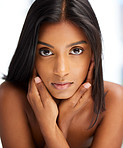 Portrait, beauty and skincare with an indian woman in her home, feeling beautiful or fresh. Face, hair and relax with an attractive young female in her apartment looking confident or feminine