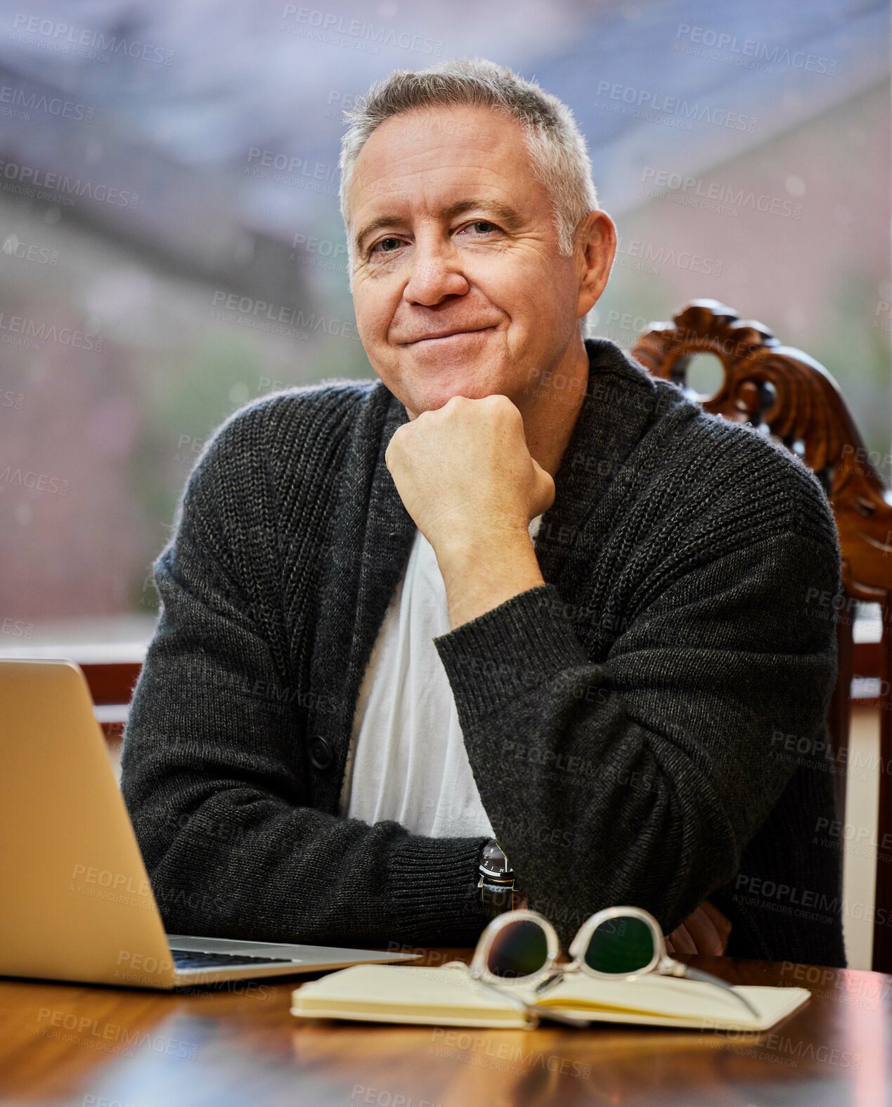 Buy stock photo Cropped portrait of a handsome senior man working on his laptop in the study