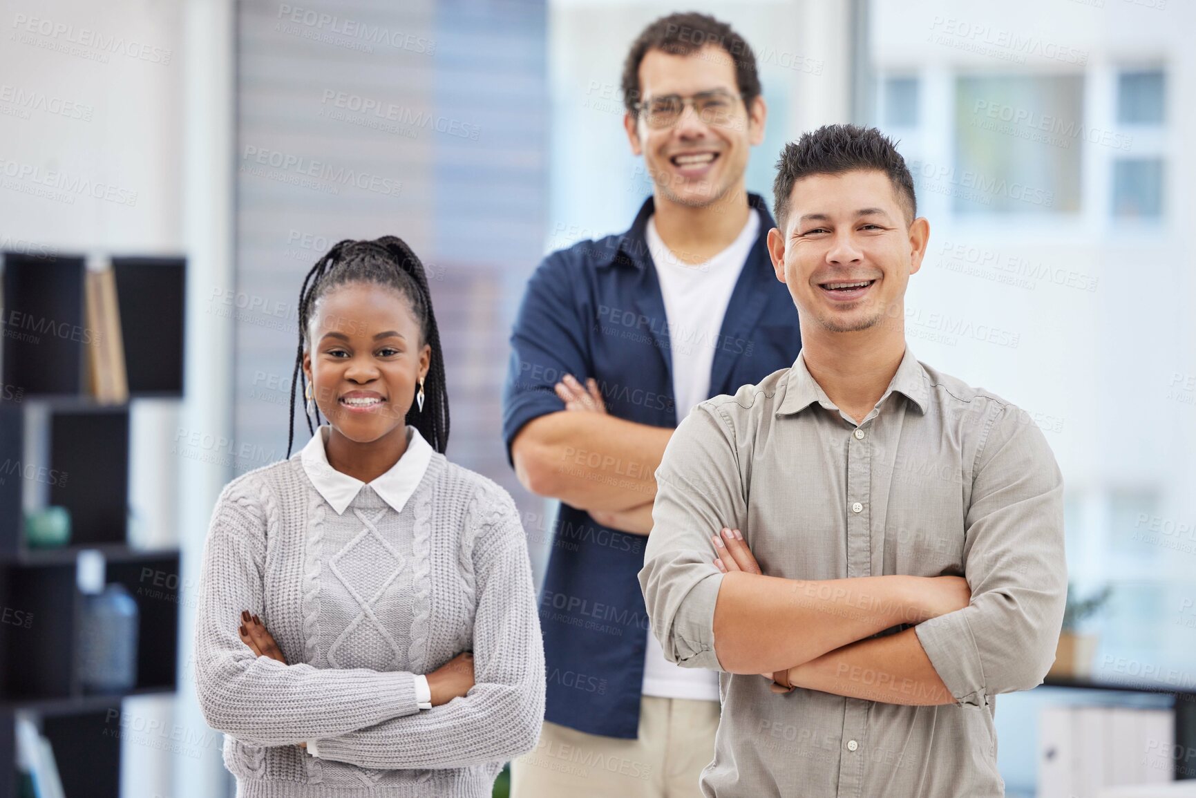 Buy stock photo Shot of a diverse group of businesspeople standing together in the office with their arms folded