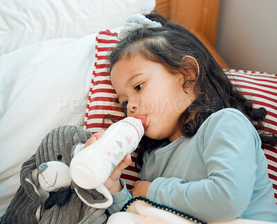 Buy stock photo Home, milk and bottle for little girl to drink, enjoy and rest on bed of bedroom in apartment. Toddler, calm and feeding on formula for nutrition, growth and development of child in nursery of house