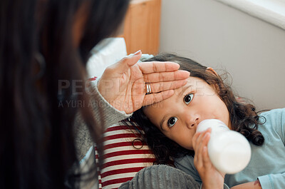 Buy stock photo Little girl, fever and hand of mom in house, milk and bottle for cute toddler to drink. Mother, check and touch head of child for sickness in youth, kid and daughter with mama as family in home