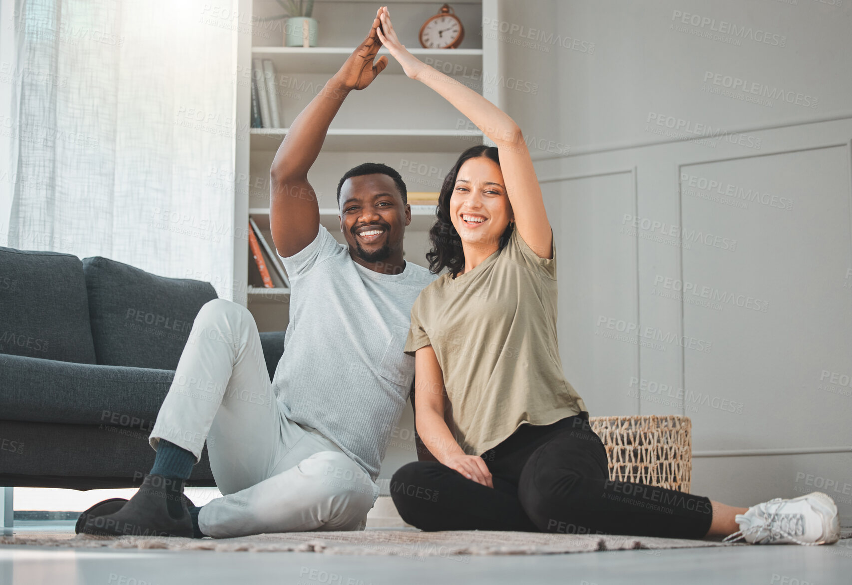 Buy stock photo Safety, roof hands or portrait of happy couple in living room at home for support, care or insurance. Interracial, property investment or parents with smile for security cover, future or protection