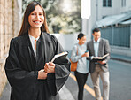 Lawyer, woman and portrait with book in city for law, justice and human rights with pride for job at court. Attorney, advocate and person with smile, notebook and documentation for evidence in street