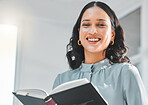 Business, woman and legal book for planning, reading and research with case study at a law firm. Portrait of a young attorney, paralegal or lawyer with textbook for policy, justice and human rights