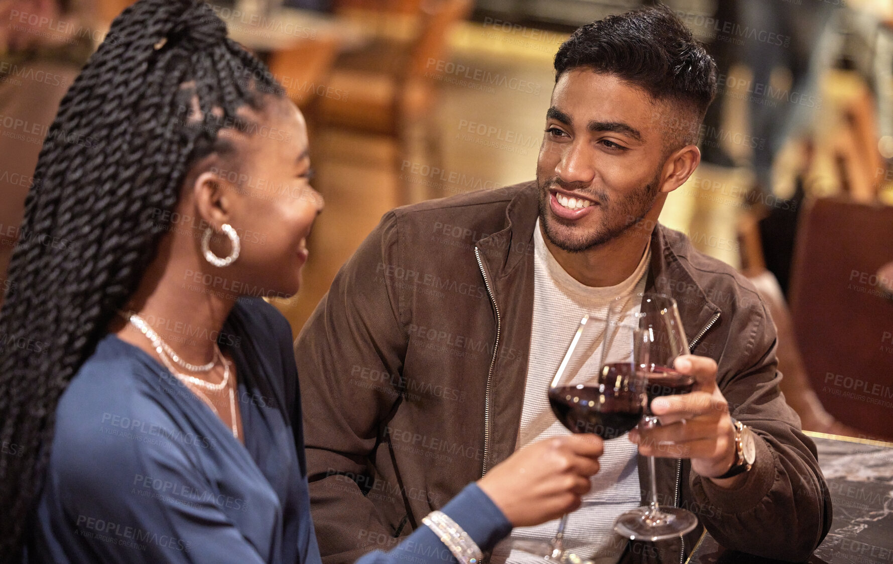 Buy stock photo Cheers, conversation and couple with wine on date at gourmet, romantic and luxury restaurant. Happy, love and young man and woman with alcohol drink to toast for anniversary celebration at diner.