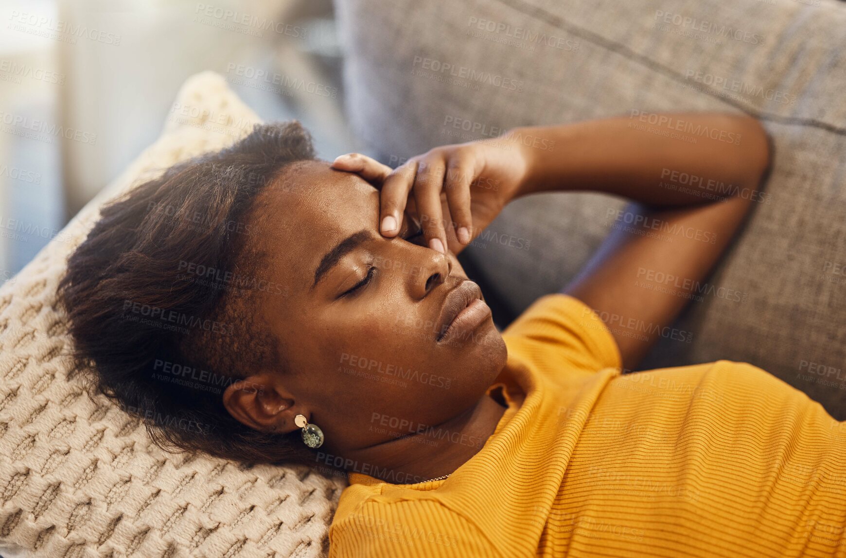 Buy stock photo Tired, bored and exhausted female sleeping on a couch at home. African female relaxing and resting on a sofa due to headache or migraine in her house. Lady lying down and dreaming while taking a nap