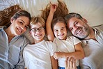 Top view, family or children bonding in bedroom in house, home or hotel and parents in trust, love or security. Portrait, smile or happy kids with mature father and mother or man and Australian woman