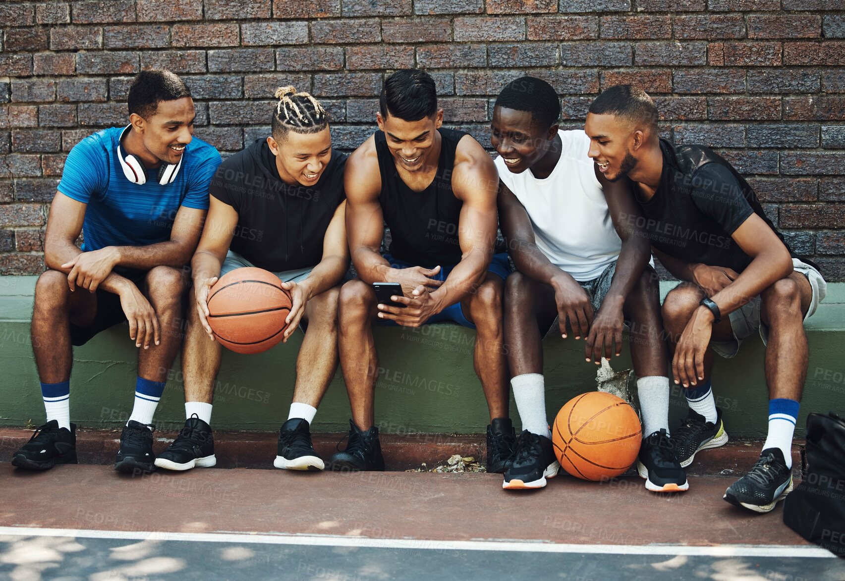 Buy stock photo Basketball friends, rest together with phone and relax watch a funny video on smartphone after training on sports court. Healthy men, relax and tired on bench after workout game for fitness exercise 