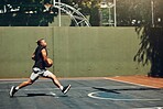 Young black man, basketball fitness outdoor training and running on court. Athletic sport wellness exercise, healthy lifestyle vision and professional player train for competition in sports park
