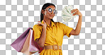 Woman, shopping bag and money fan, wealth and commerce with customer in sunglasses on blue background. Cash, financial freedom and retail, fashion and product choice, rich and shop discount in studio