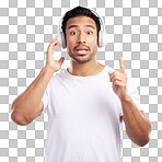 Handsome young mixed race man looking surprised and listening to music while standing in studio isolated against a blue background. Hispanic male remembering a song while using wireless headphones