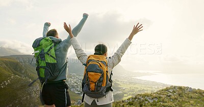 Couple, mountain top and freedom or celebration of hiking goals, travel and trekking adventure in nature. Back of happy people or winner with arms up for success or excited on a cliff and cityscape