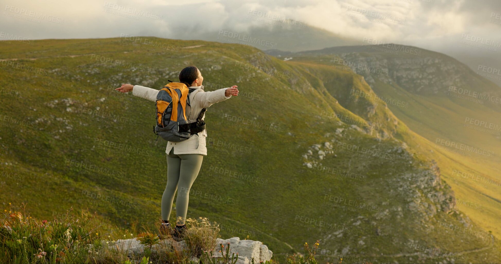 Buy stock photo Woman, mountain top and freedom, trekking goals, celebration or travel achievement in nature adventure. Person or winner in backpack with arms up for hiking success, energy and yes on a cliff or rock