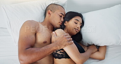 Happy couple, relax and lying on bed for embrace, love or morning romance in trust, hug or care at home. Top view of young man and woman sleeping in bedroom for intimacy, rest or bonding at house