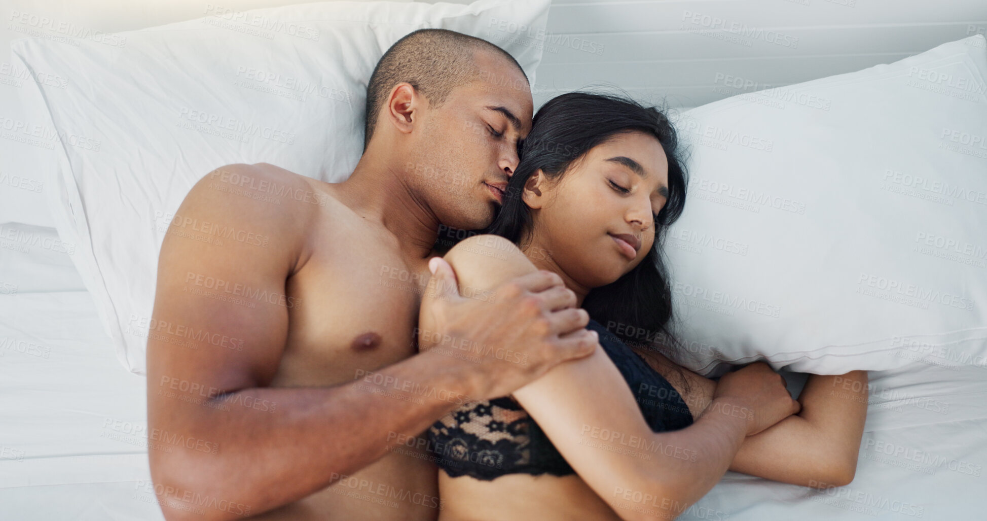 Buy stock photo Happy couple, relax and lying on bed for embrace, love or morning romance in trust, hug or care at home. Top view of young man and woman sleeping in bedroom for intimacy, rest or bonding at house