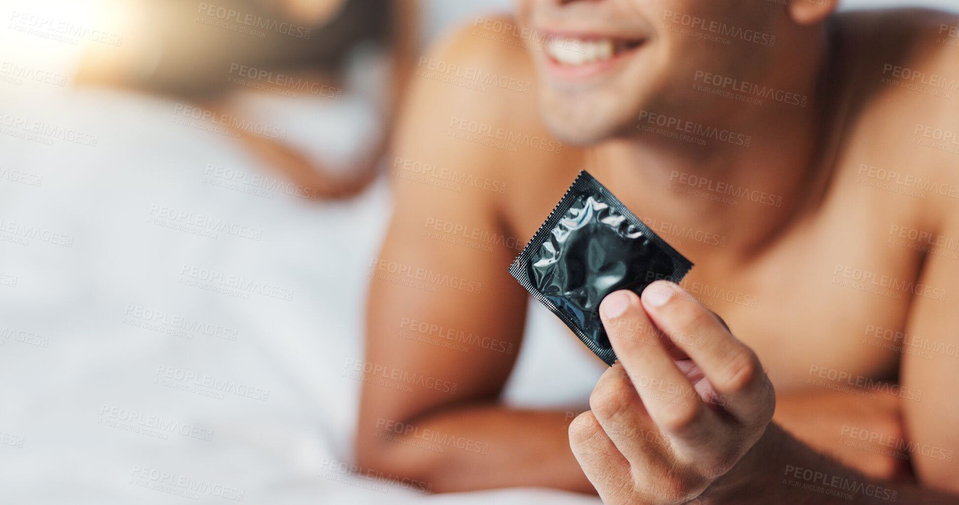 Buy stock photo Man, condom and contraceptive for protection in bedroom, smile and proud for responsible choice at home. Couple, security and happy for safety in sex, rubber and prevention of hiv and sexual illness