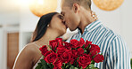 Couple, flowers and kiss for anniversary celebration, marriage and loyalty or commitment to love. People, happy and romance for relationship milestone, bonding and plant gift for support at home