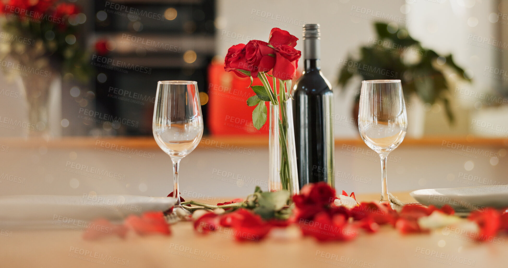 Buy stock photo Wine, glass and romance on valentines day for celebration of love, anniversary or honeymoon in still life. Flowers, dinner and elegant date in dining room of home for event, milestone or occasion