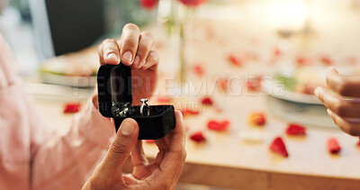 Couple, hands and proposal with ring for love, marriage and celebration on valentines day or anniversary dinner. Closeup of people with jewelry for engagement with finger for romance and commitment