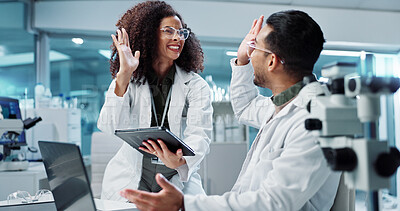 Science, teamwork and high five with laptop in laboratory for test breakthrough, pharmaceutical review or excited. Scientist, collaboration or mentor for research success, talking or digital analysis