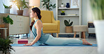 Exercise woman, yoga stretching and home fitness in living room floor for wellness, balance training and strong body. Healthy lady, pilates focus and flexible cobra workout training in house lounge