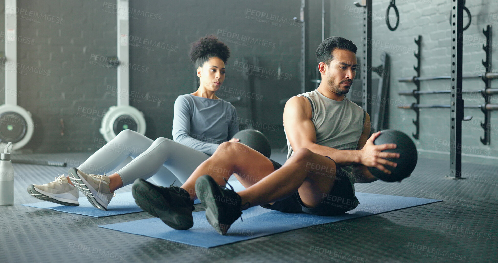 Buy stock photo Fitness, energy and friends on gym floor with weight ball for training, power and exercise together. Cross, workout and black woman with man for sports, power and cardio in strength, core and mindset