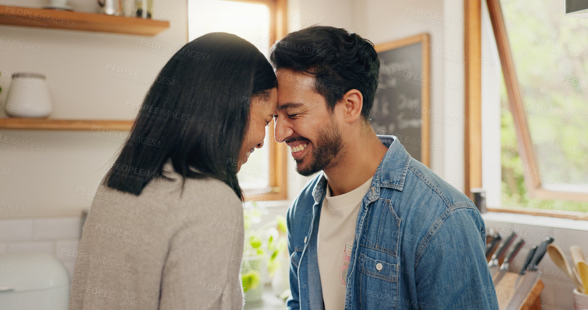 Buy stock photo Love, hug and happy couple in a kitchen talking, together and intimate while bonding in their home. Embrace, romance and man with woman hugging, smile and sharing moment, conversation and laughing