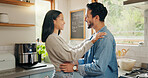 Hug, happy and couple in a kitchen bonding, intimate and talking in their home together with intimacy. Love, face and woman embrace man with smile, care and sharing romantic moment and conversation