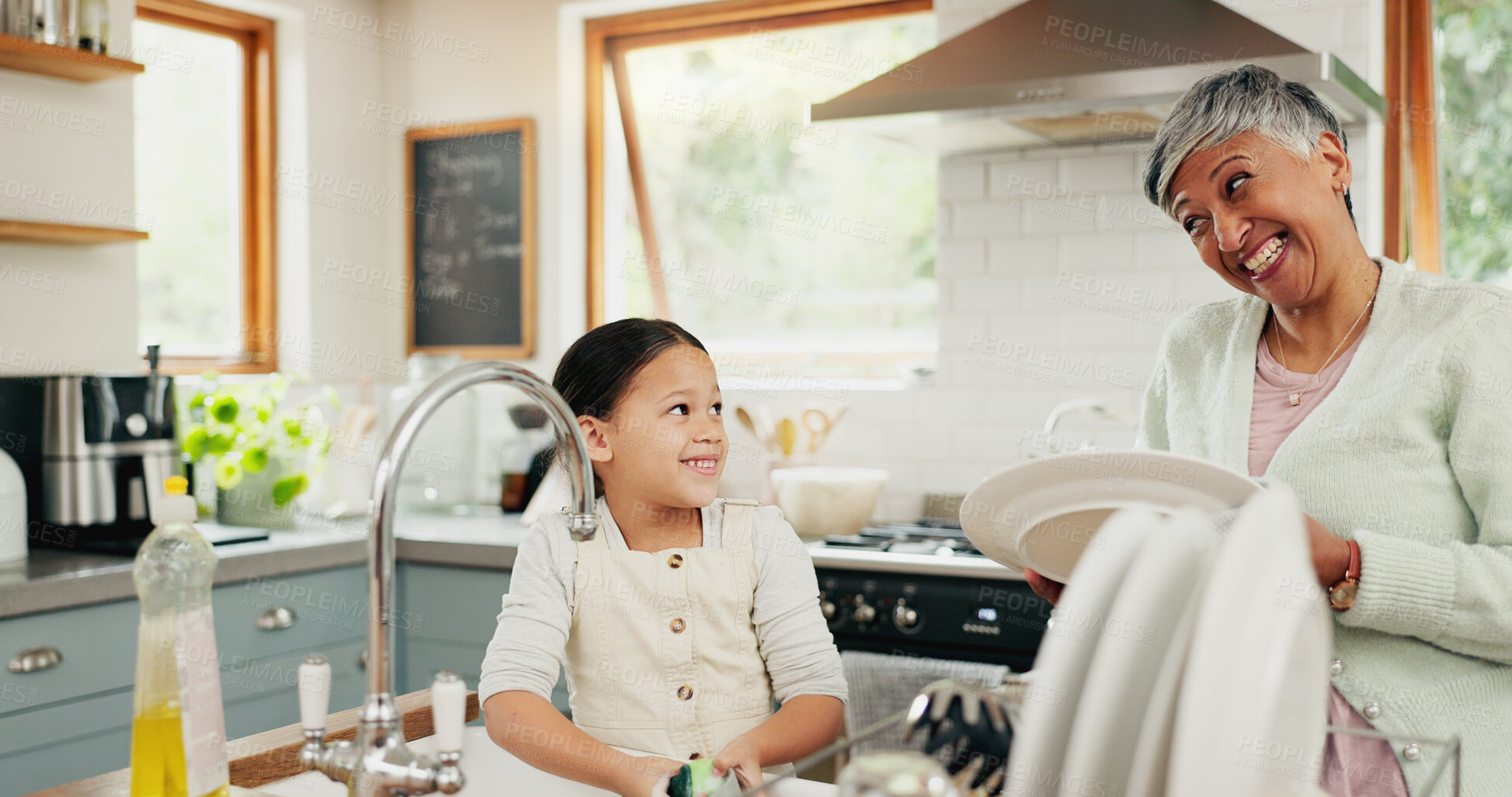 Buy stock photo Happy, grandmother and child washing dishes with help, teaching and learning from a senior. Smile, support and an elderly woman and a girl kid cleaning the kitchen together in a house for routine