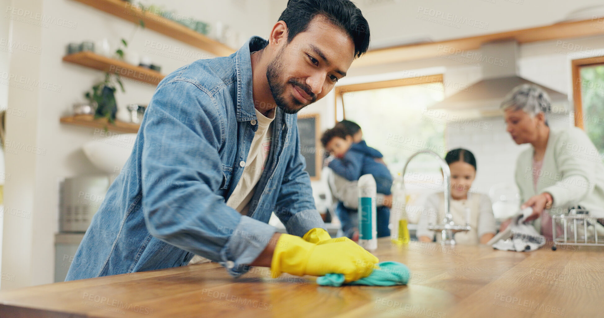 Buy stock photo Family, cleaning and man in a kitchen with cloth for table, hygiene or clean living space after dinner. House, disinfection and guy parent with household chore for safety from bacteria, dirt or germs