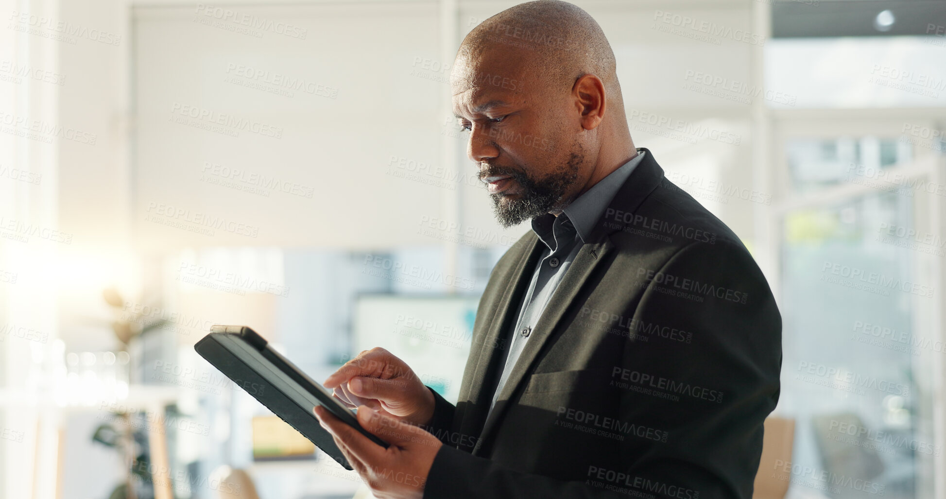 Buy stock photo Black man in office with tablet, email or social media review for tech business, schedule or agenda. Internet, digital app and businessman networking online for market research, website and report.