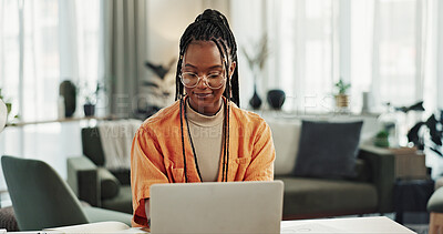 Black woman, typing in home office and laptop for remote work, social media or blog research in apartment. Freelance girl at desk with computer writing email, website post and online chat in house.