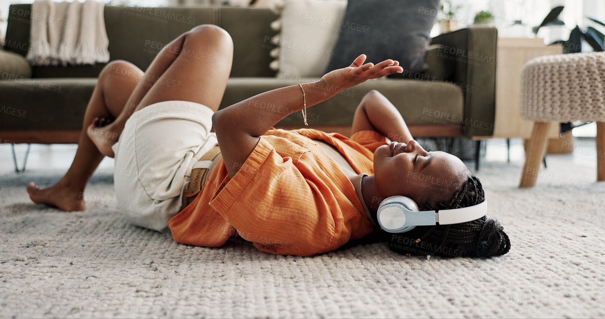 Buy stock photo Music, headphones and black woman on floor, listening to song and audio in living room. Happy African person on radio, streaming sound and technology for freedom, relax on carpet and smile in home