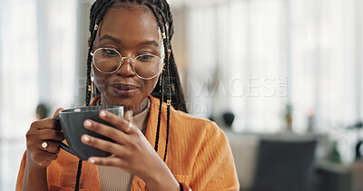 Calm, cup of coffee and black woman in the living room of her modern apartment in the morning. Peaceful, mug and young African female person drinking caffeine or latte in her home on weekend.