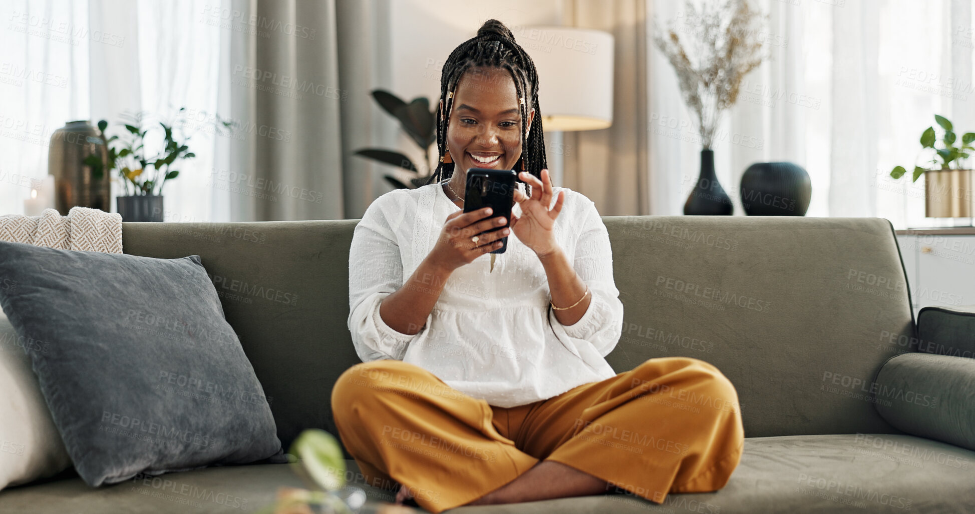 Buy stock photo Home, funny and black woman on a sofa, cellphone and connection with social media, comedy post and laugh. African person, apartment or girl on couch, smartphone or mobile user with humor or typing