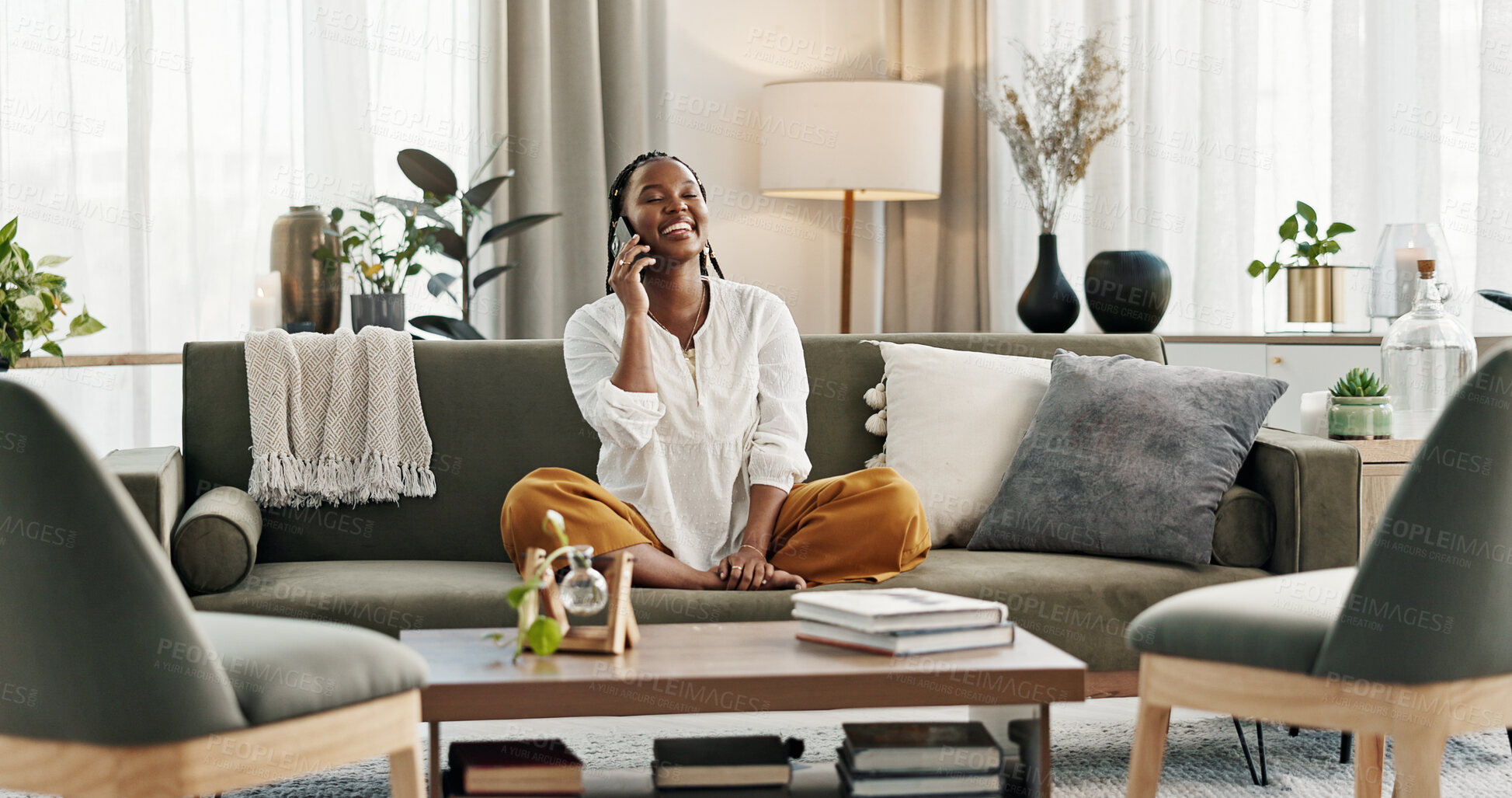 Buy stock photo Black woman on sofa, relax and phone call for good news, conversation and connection with smile in home. Happy girl on couch with smartphone, funny discussion and online chat in living room of house