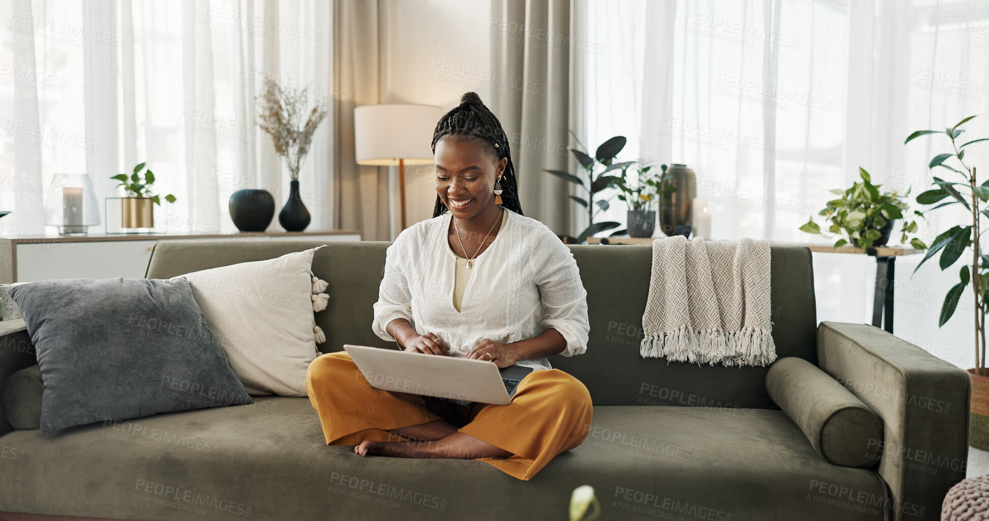 Buy stock photo Black woman on sofa, smile and typing on laptop for remote work, social media or blog post research in home. Happy girl on couch with computer checking email, website or online chat in living room.