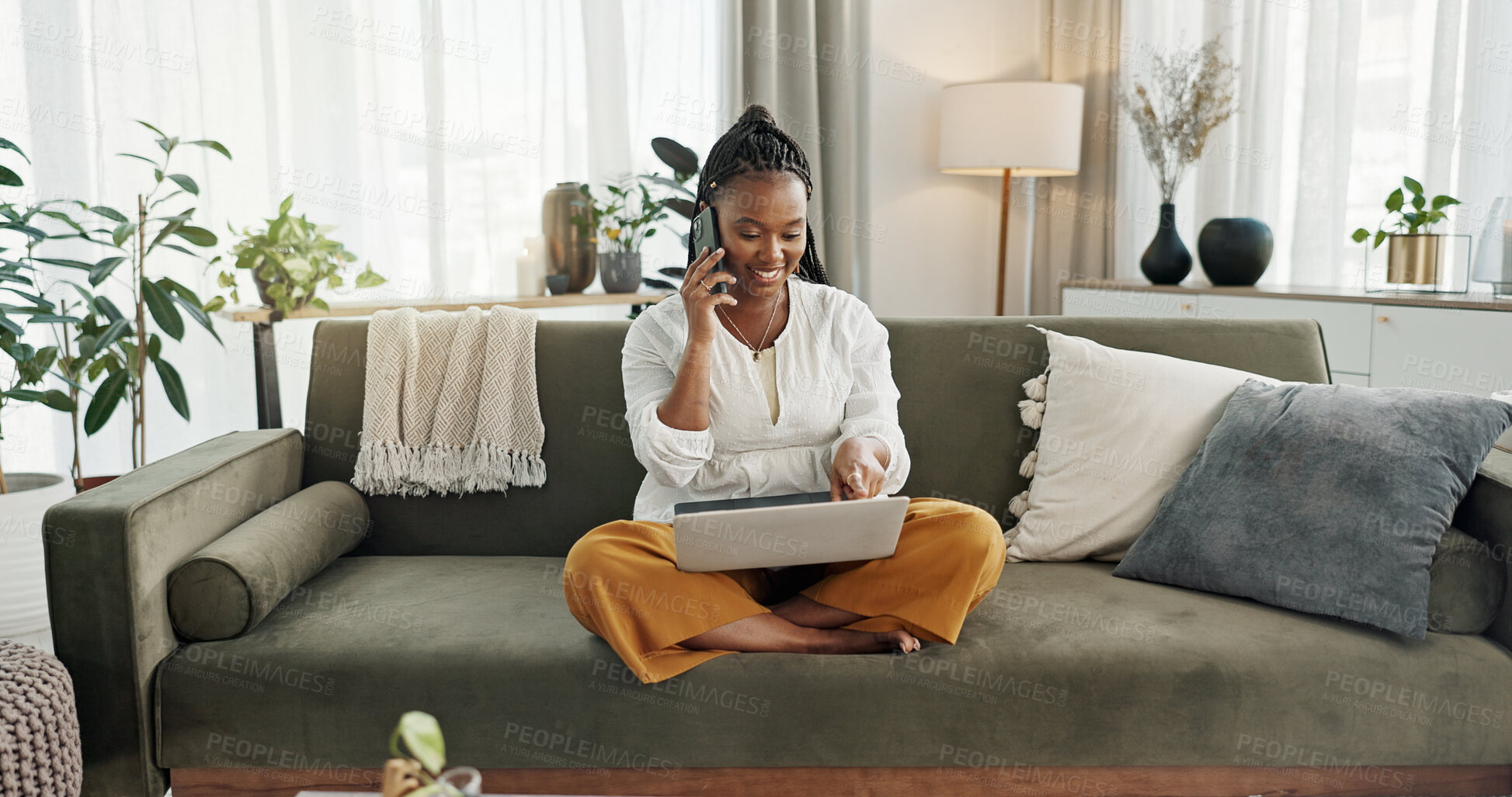 Buy stock photo Black woman on sofa, phone call and laptop for remote work, social media or blog post research with smile in home. Happy girl on sofa with computer, cellphone and online chat in house for networking