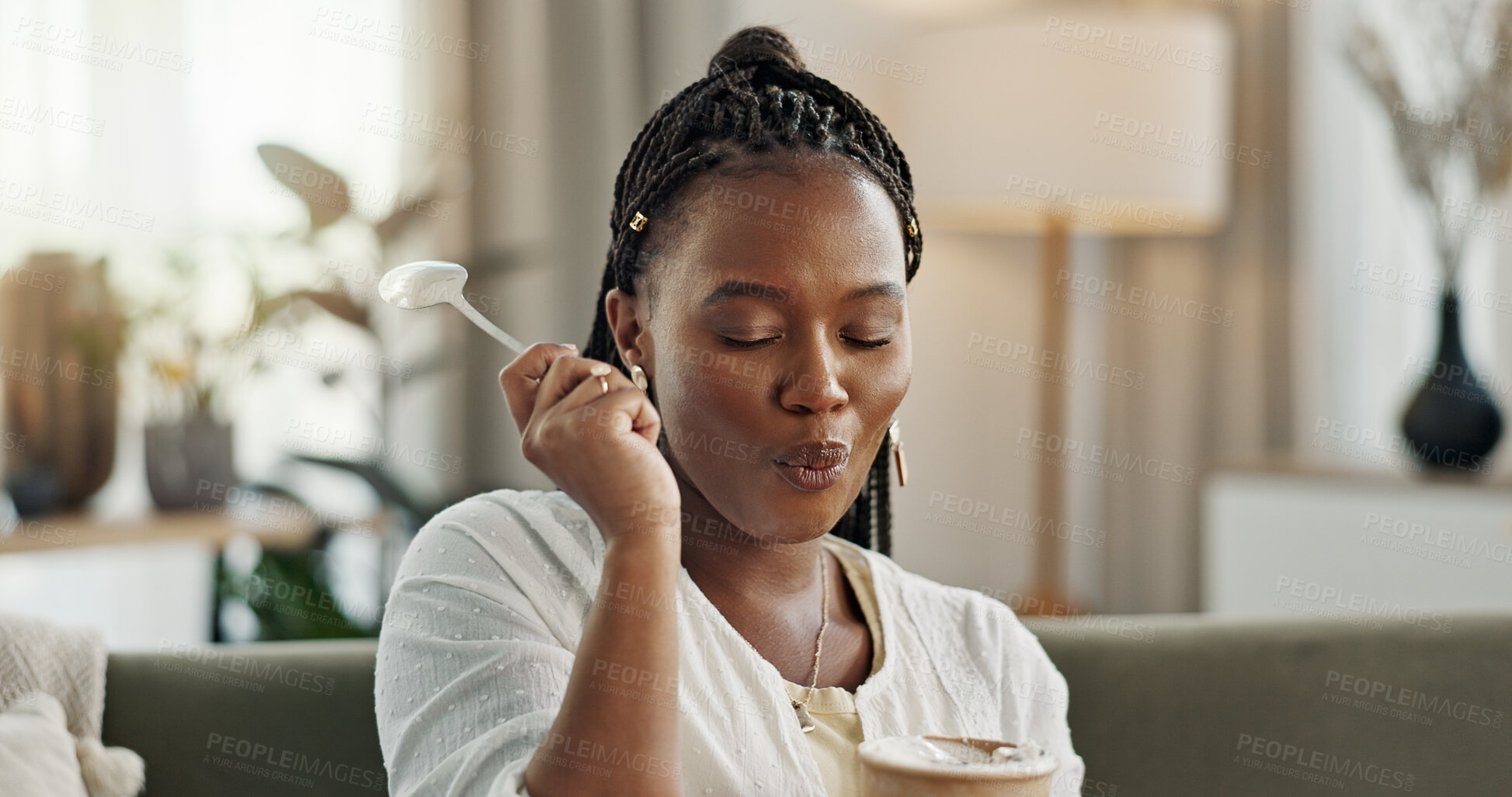 Buy stock photo Black woman on sofa, eating ice cream and relax in living room with smile, summer pleasure and enjoy. Happiness, fun or thinking, girl on couch with taste of frozen chocolate getalo dessert in home.