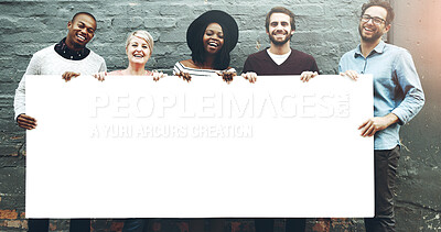 Buy stock photo Shot of a diverse group of people holding a blank placard against a gray brick wall