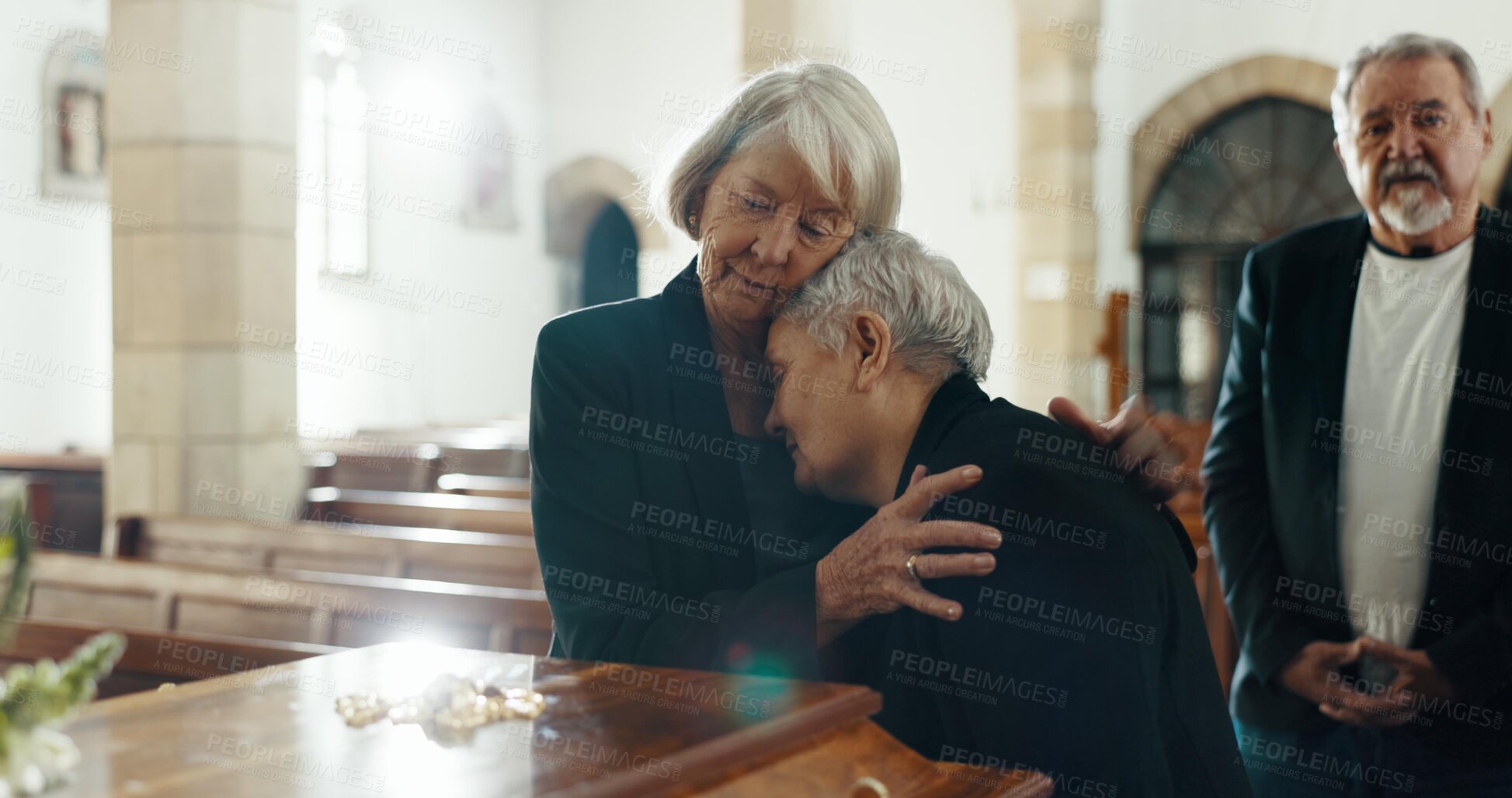Buy stock photo Senior, women and sad with hug at funeral in church for religious service, comfort and mourning. Grief, elderly people and burial with death, ceremony and grieving loss or bereavement at chapel event