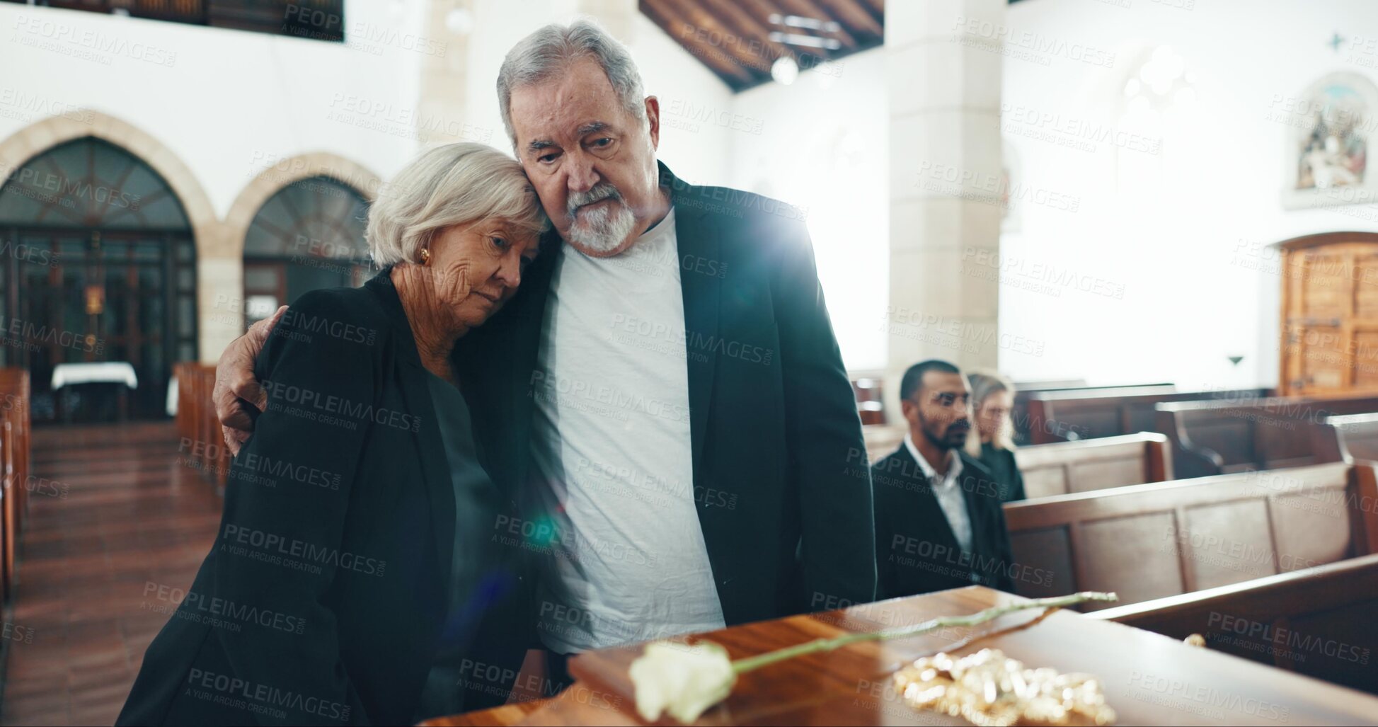Buy stock photo Senior, couple and sad with hug at funeral in church for religious service, comfort or mourning. Grief, elderly people and burial with death, ceremony and grieving loss or bereavement at chapel event