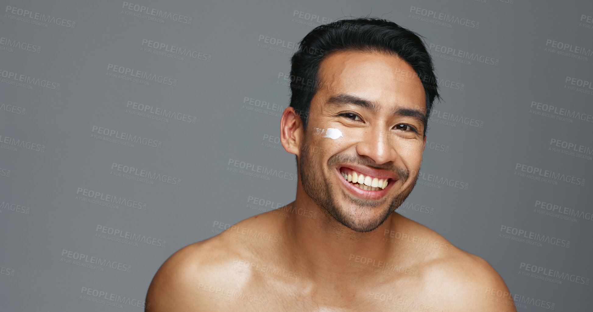 Buy stock photo Face, cream and man with skincare, dermatology and beauty with glow on a grey studio background. Portrait, person and model with creme, smooth and luxury treatment with grooming, shine and aesthetic