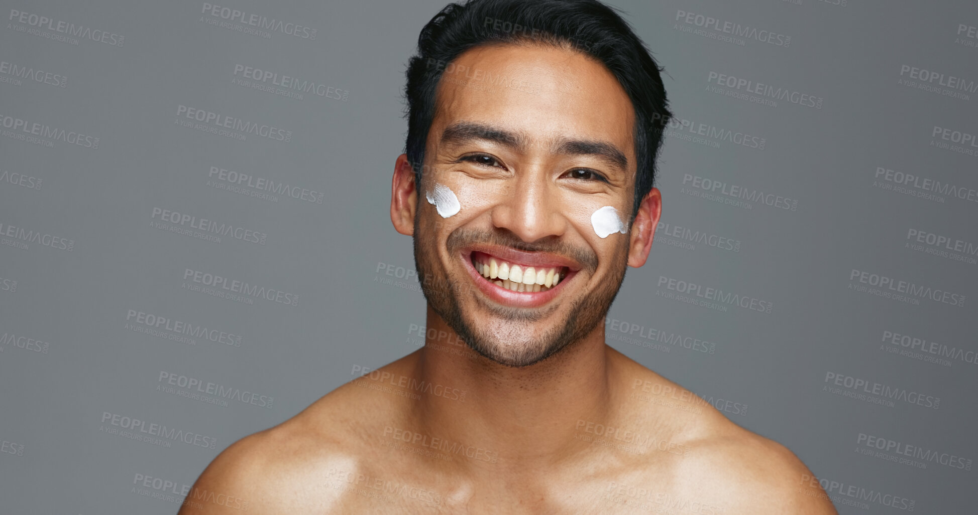 Buy stock photo Face, cream and man with skincare, glow and dermatology with grooming, wellness and shine on grey studio background. Portrait, person or model with creme, beauty or cosmetics treatment with aesthetic